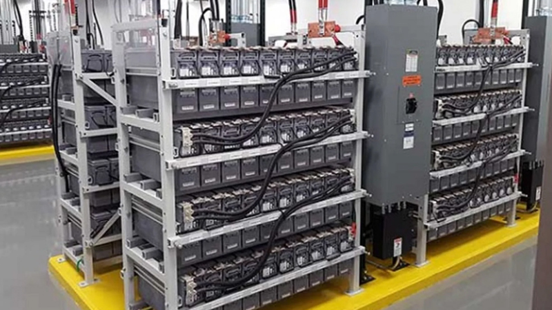Industrial battery dealer in India displaying VRLA, tubular and lithium-ion batteries for UPS and solar backup in a factory