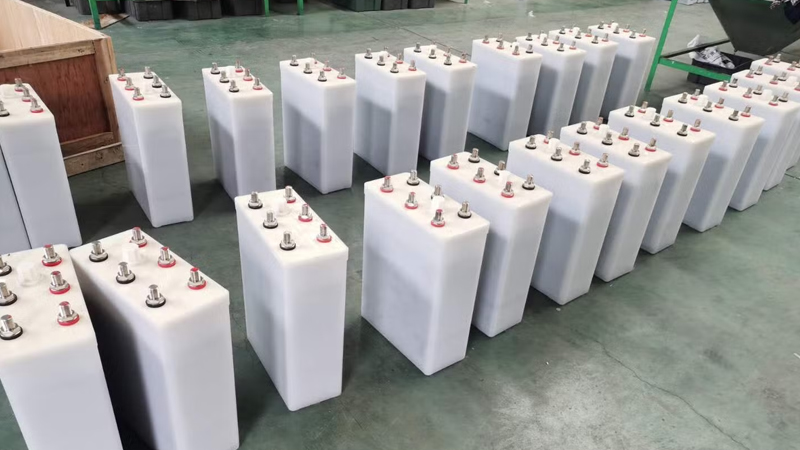 Industrial nickel cadmium (NiCad) battery bank installed on steel racks in an Indian substation DC room, with series‑connected cells and insulated busbars